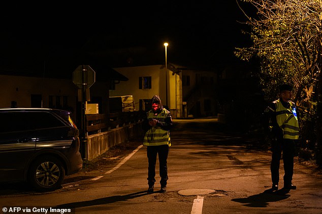 French gendarmes stand guard at the entrance to a street, near the place where three children were found dead, in Taninges, eastern France, on November 12, 2024.