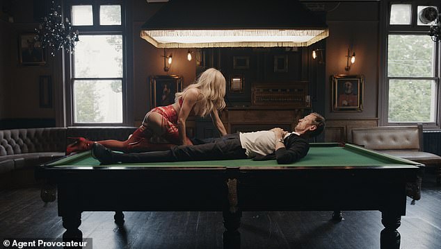 The model, 38, shows off her incredible figure in red lace lingerie and suspenders from the Forever collection, which cost a whopping £1,500, as she seduces the former footballer, 43, on a pool table.