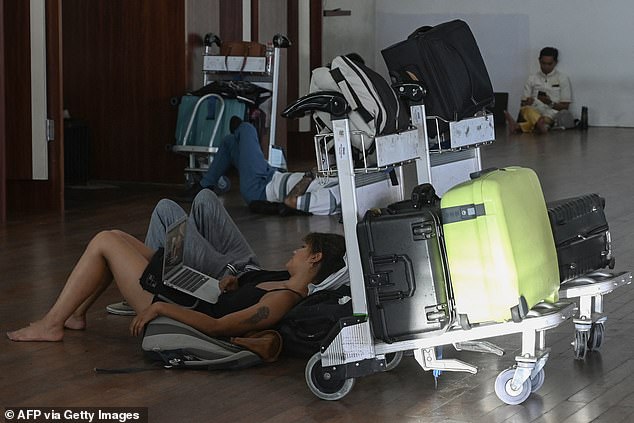 Thousands of passengers are stranded at Denpasar International Airport (pictured) as major airlines are not considering resuming flights in and out of Bali until Thursday.