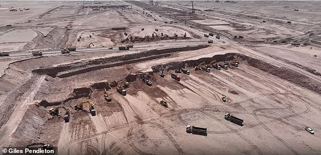 Excavators and trucks work on the foundations of The Line