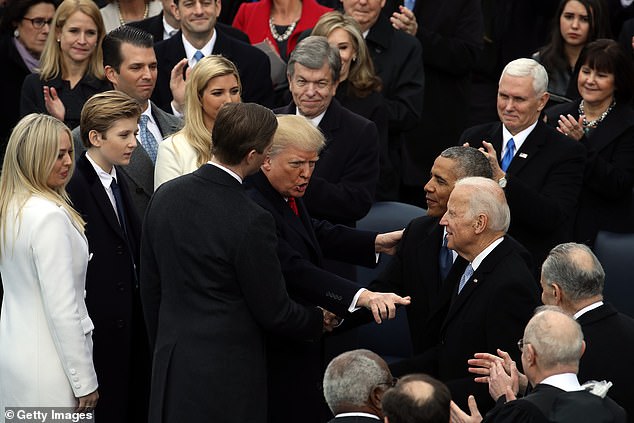 Former President Barack Obama and former Vice President Joe Biden congratulate President Donald Trump after he was sworn in on January 20, 2017.