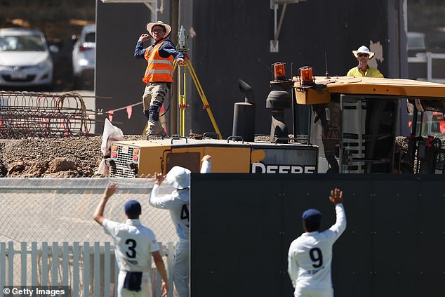 Construction workers at the iconic cricket ground are currently working on a massive $154.7 million redevelopment project (pictured: Construction workers at WACA recover a ball during a Sheffield Shield match between Western Australia and New South Wales)