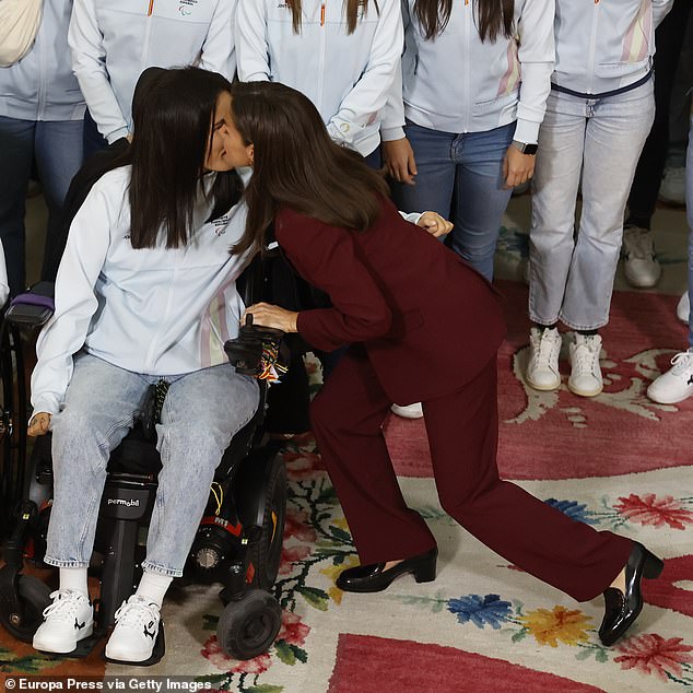 Letizia was photographed bowing and greeting a wheelchair-bound Paralympic athlete by kissing her on the cheek.