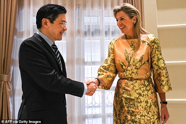 The Dutch royal, 53, appeared in high spirits as she shook hands with Mr Wong at the Istana presidential palace.