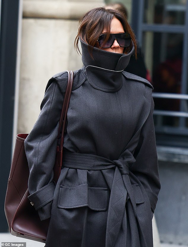 The fashion designer and new 'mom' tried to keep a low-key appearance while protecting her face with oversized dark sunglasses and a high-collared coat.