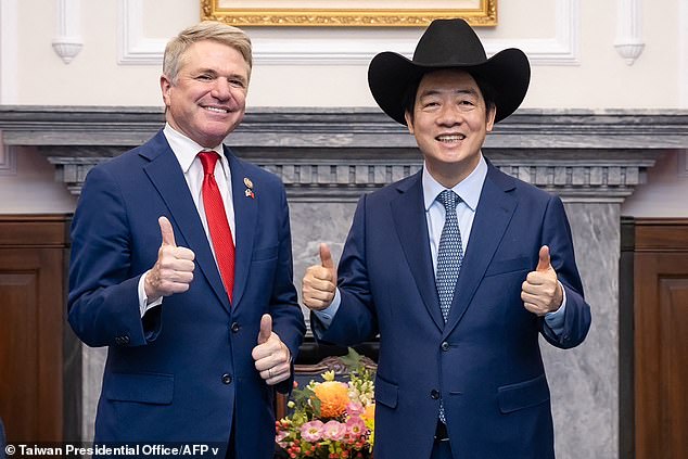 Taiwan's presidential office on May 27, 2024 shows Taiwan's President Lai Ching-te (right) posing with a hat received from McCaul.