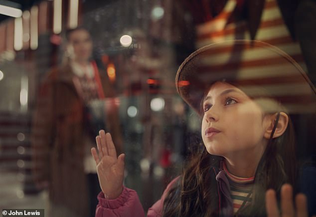 As they walk away, we see his sister reflected in the John Lewis window as the girl from his memories.