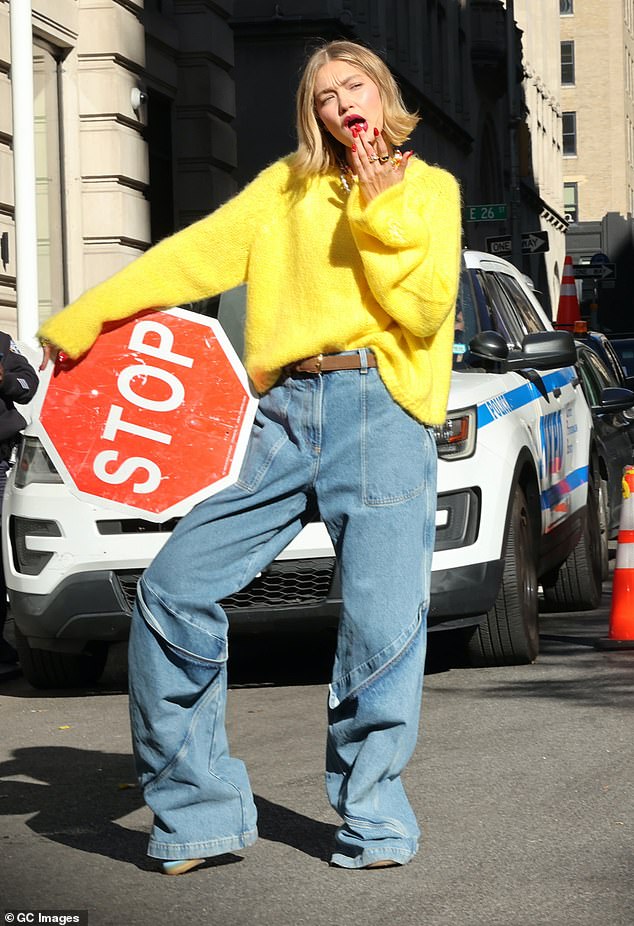 The supermodel, 29, posed in and around a yellow taxi wearing a pair of jeans and a bright yellow sweater.