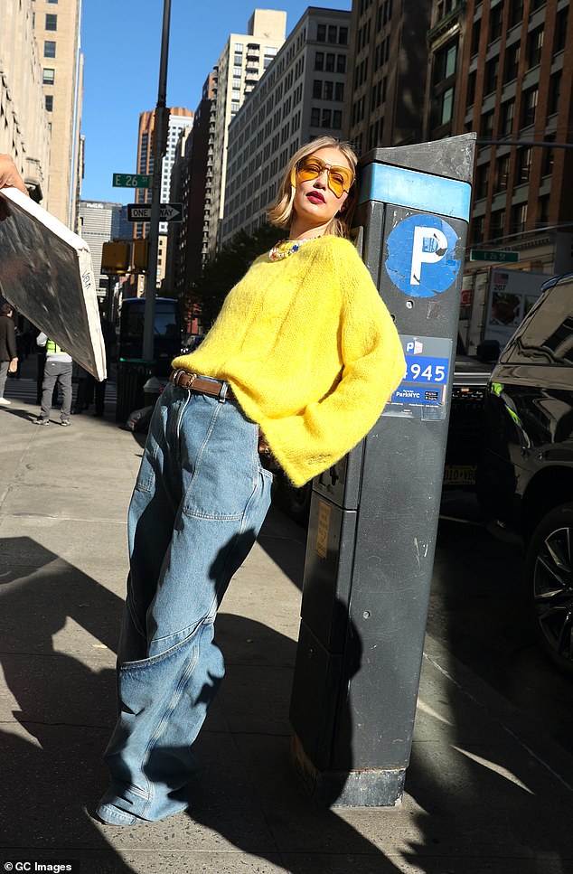 Gigi was also seen looking sultry in a white rose, clowning around with a stop sign and sitting on the hood of a taxi.