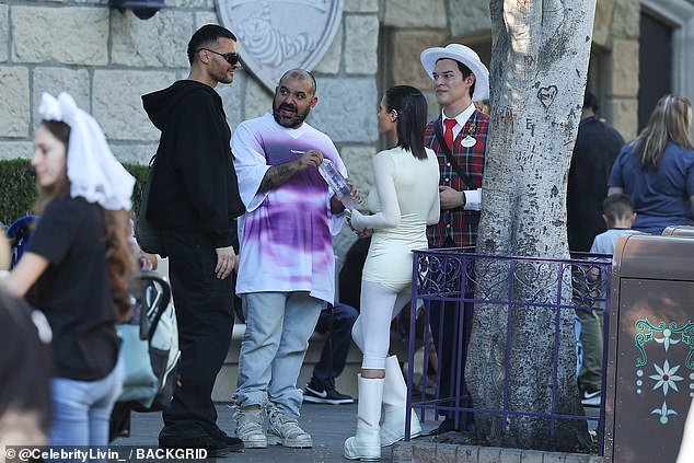 The blouse contrasted with the pale white blouse with long sleeves poking out from underneath.