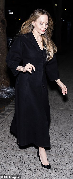 Jolie layered her outerwear over a black ensemble, which she accessorized with a pair of black pointy-toe heels.