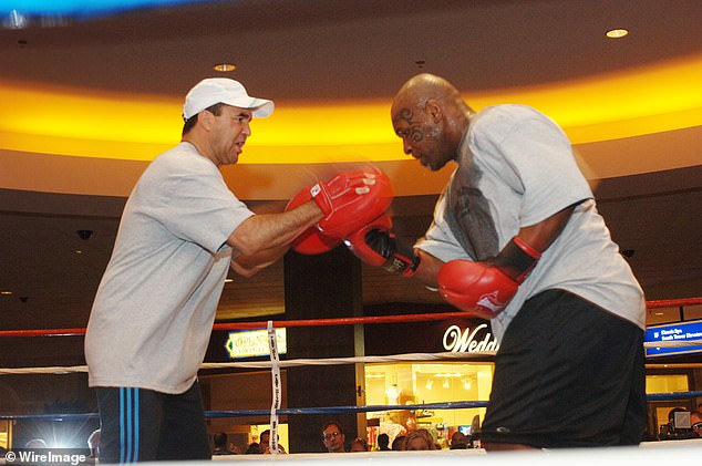 Fenech is shown training Mike Tyson for a fight in March 2005. The two world champions have been friends for decades.