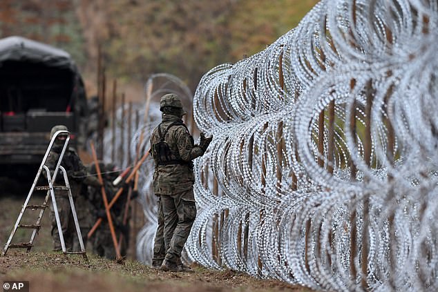 Polish soldiers begin placing a barbed wire barrier along Poland's border with the Russian enclave of Kaliningrad in November 2022.