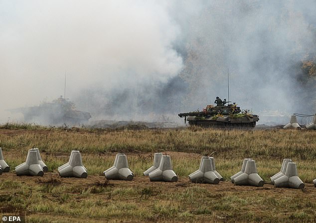 Polish soldiers operate armored tanks during defense program military exercise 