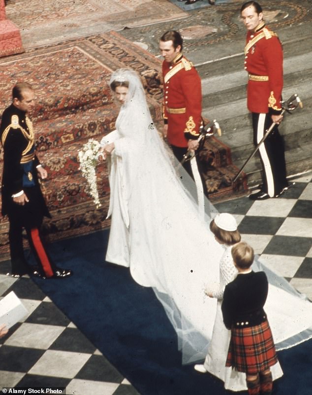 The princess wore a Tudor-style wedding dress made by Maureen Baker, chief designer of Susan Small. At the time, scholars claimed that Anne was probably inspired by Queen Elizabeth I, rather than her own mother, Queen Elizabeth II.