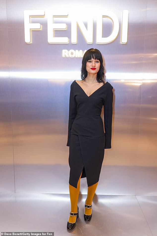 Emma Winder looked quirky in a structured midi dress and yellow tights