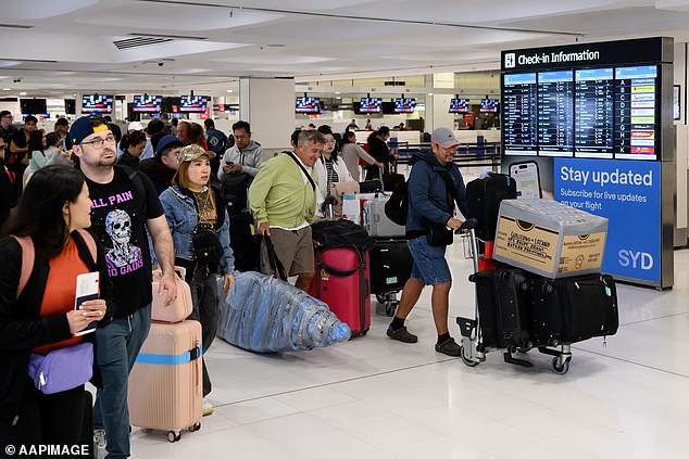 Jetstar, Qantas and Virgin Australia resumed flights in and out of Bali on Thursday. Pictured are passengers at Sydney International Airport.