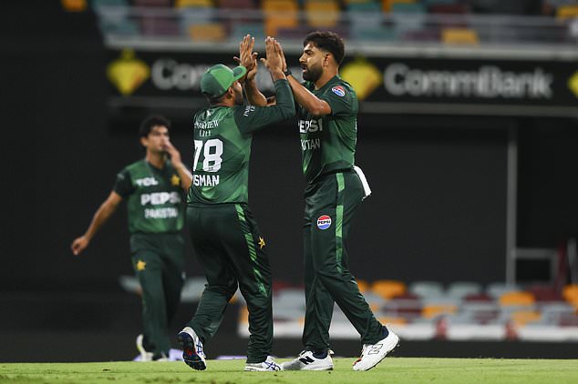 Pakistan's Haris Rauf and Usman Khan, left, celebrate the dismissal of Australia's Matt Short during the T20 international cricket match between Pakistan and Australia at the Gabba in Brisbane, Australia, Thursday, Nov. 14, 2024. (AP Photo /Tertius Pickard)