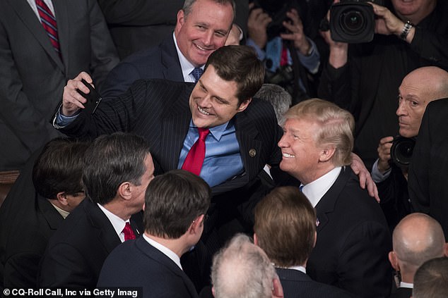 President Donald Trump takes a selfie with Rep. Matt Gaetz, R-Fla., in the House chamber after Trump's State of the Union address during a joint session of Congress on Jan. 30, 2018.