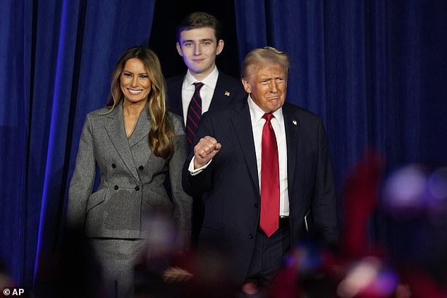 Republican presidential candidate former President Donald Trump, accompanied by Melania Trump (left) and Barron Trump, arrives to speak at an election night watch party.