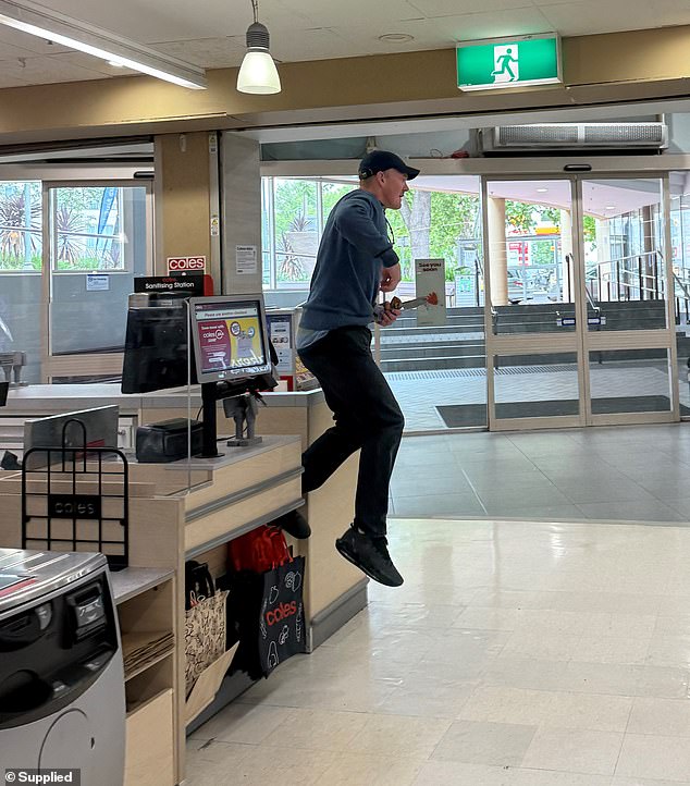 The unidentified man is accused of stealing cash from two cash registers behind the store's service counter before fleeing on foot.