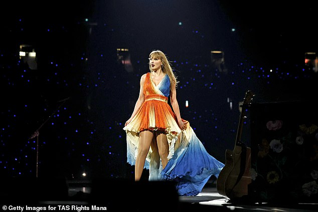 . She also wore an orange and blue minidress with a pleated detail.