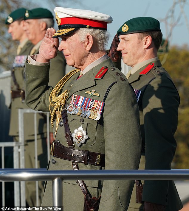 King Charles salutes during a visit to the Royal Marines Commando Training Center