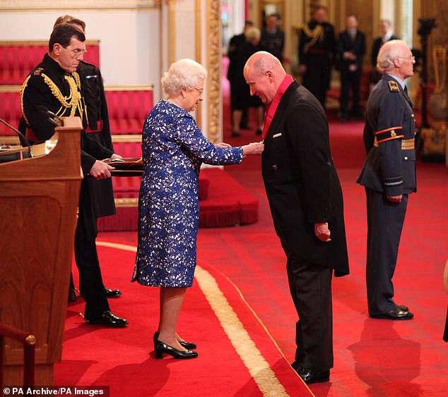 Lord Christopher Geidt is appointed Knight Commander of the Order of the Bath by Queen Elizabeth II at Buckingham Palace in March 2014