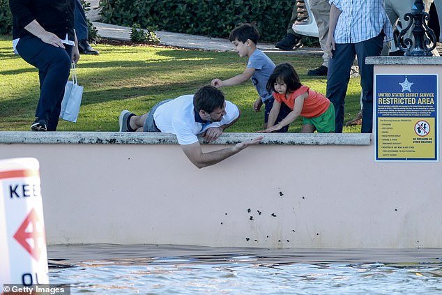 Father JD Vance joins in and shows his children a shell plucked from the sea wall