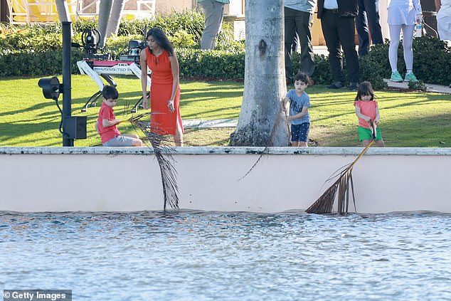 The children pretend to go fishing with palm leaves