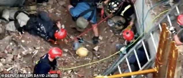 Incredible footage showed workers searching through concrete to unearth the construction worker, with only the top of his helmet visible