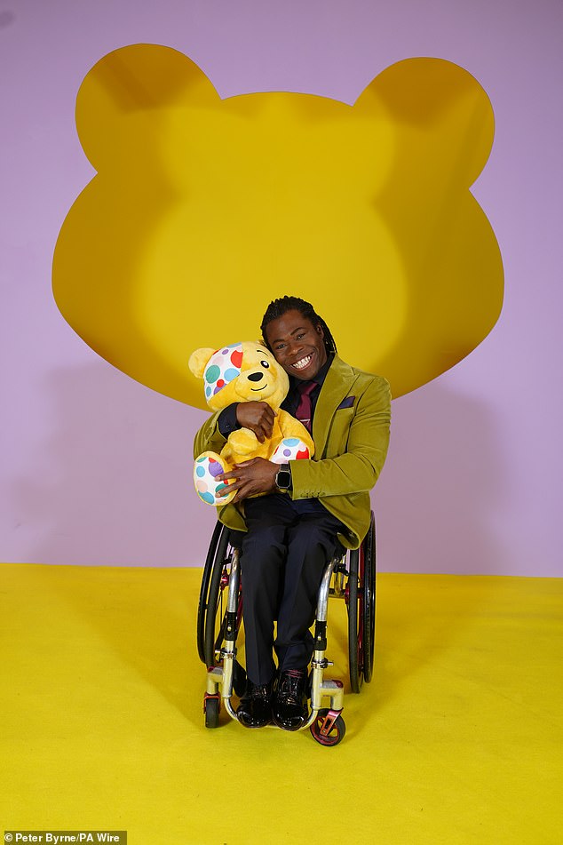 Ade Adepitan stood out with an olive green blazer and red tie