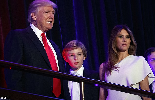 Melania (pictured with Barron in 2016) appears to be avoiding the chaos surrounding DC