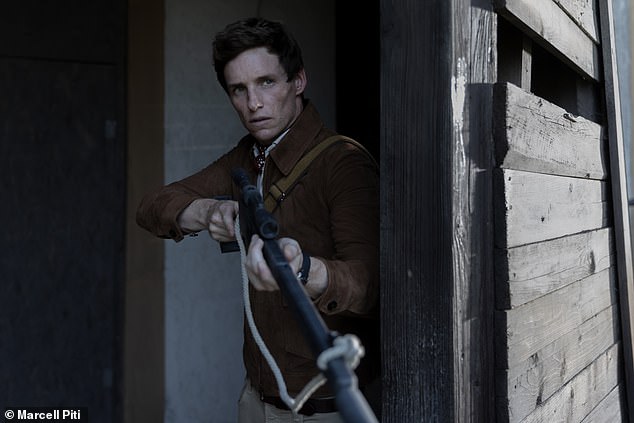 Redmayne wielding a gun as lone assassin The Jackal.