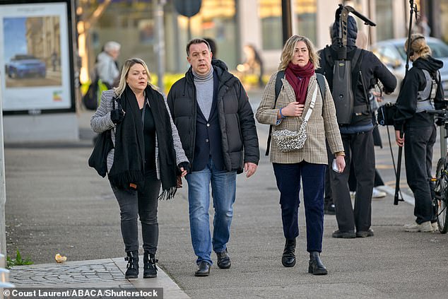 Gisele Pelicot's children, Caroline Darian (R) and David (C), arrive at court today.