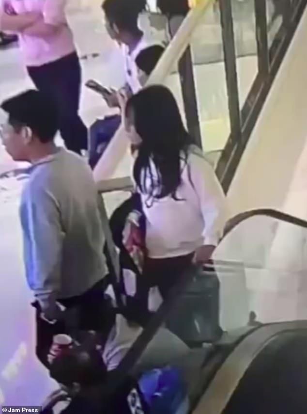 Horrifying CCTV footage of the incident shows the woman, who has not been named, leaning on the escalator before attempting to climb onto the moving handrail.