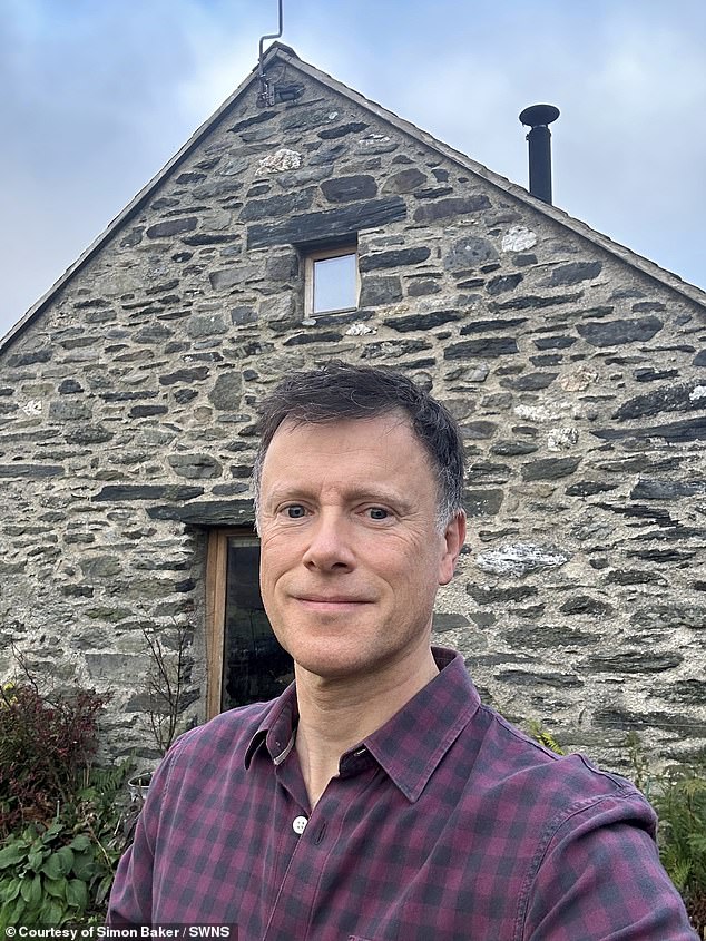 Simon Baker, 52 (pictured), sold his one-bedroom flat in London to buy a derelict Eryri cow barn in the Machno Valley, north Wales.