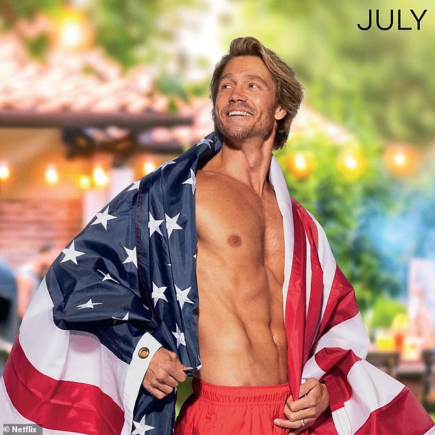 Getting into the Fourth of July spirit, he poses shirtless with an American flag draped over his body.