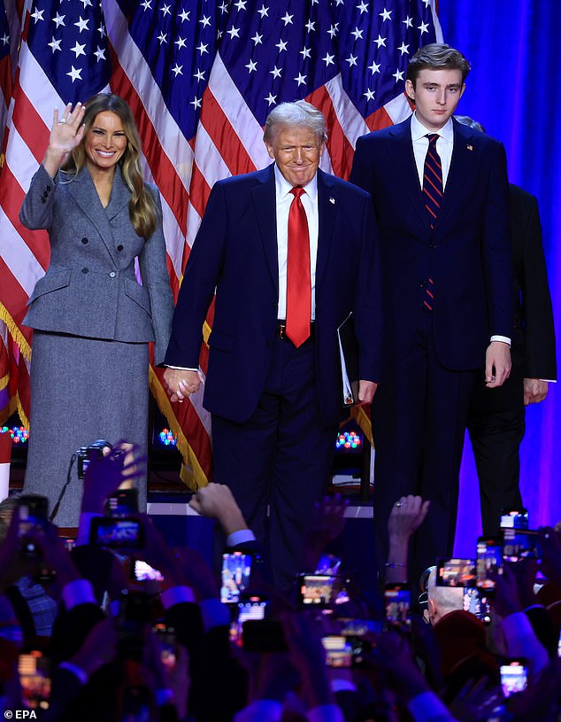 Barron towers above his parents and his now 18-year-old student at New York University's Stern School of Business.