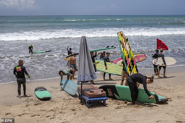 Indonesia's blasphemy laws cover the country's major religions, including Islam, Christianity, Hinduism and Buddhism, and apply to comments made online (pictured, tourists in Kuta, Bali).