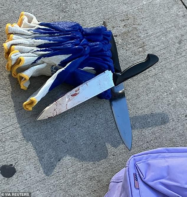 A bloody knife found at the scene lies on the sidewalk after Rivera was arrested Monday