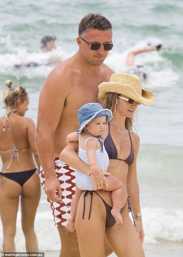 Following a western beach theme, Lucy accessorized with a cowboy-style straw hat and a pair of dark sunglasses.