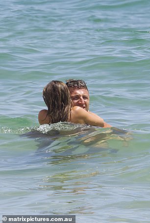 The loved-up couple weren't afraid to pack their PDA in the waves, happily kissing as the waves hit their bodies.