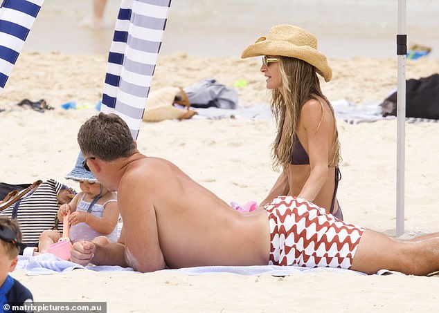 Lying with their backs to the sun, Lucy and Sam happily worked on their tans and relaxed in the sand.