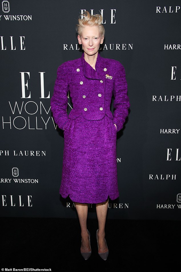 Tilda Swinton stood out in a bold purple tweed jacket with shiny gold buttons and a matching pencil skirt.