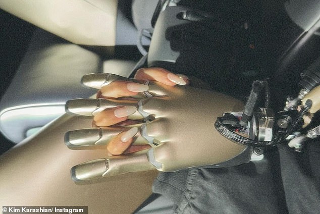 In another shot, Kim and the robot were seen holding hands in the luxury electric vehicle