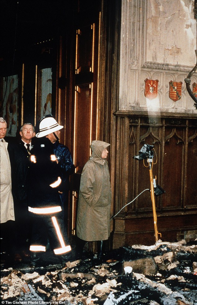 The Queen inspects the damage after the fire on November 21