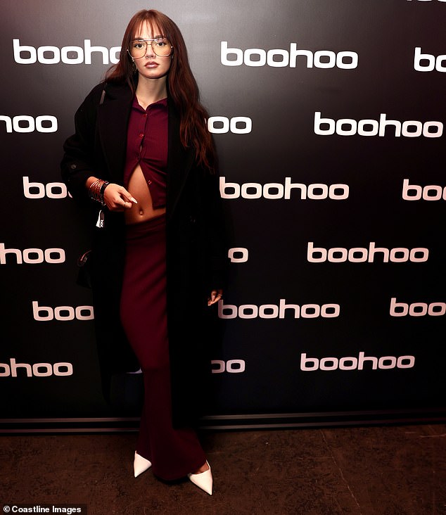 Daisy showed off her toned midriff in a burgundy ensemble which she paired with white stilettos and a long coat.