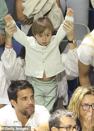 One last time! Rafa Jr raises his hands while his father takes the field