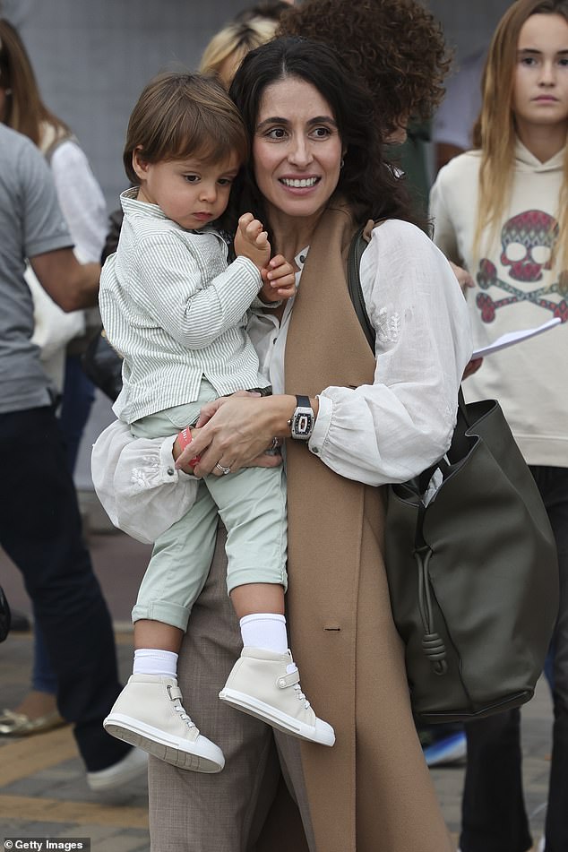 Rafa Jr wore pale green chinos with a matching striped shirt and impeccable cream-colored high-top sneakers.